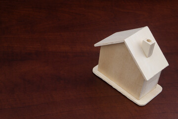 Small wooden house on table with copy space, real estate concept