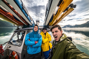Friends on whale wathcing and kayak expedition having fun on the boat in Alaska trip © Nick Starichenko