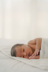 Obraz na płótnie Canvas african american new born baby lying on white bed