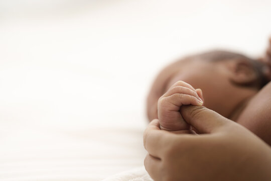 african american infant baby lying on bed