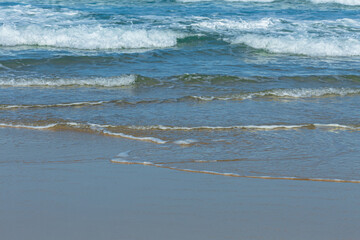 Foam and sea wave on the sand.