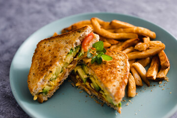 plant-based food,  vegan avocado tomato and dairy-free cheese sandwiches with french fries