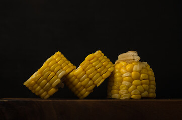 Corn black background, healthy organic food, bio nutrition, fresh ripe vegetable, maize cob, golden textured wallpaper, vegetarian eating and diet concept