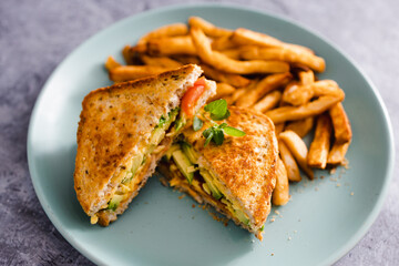 plant-based food,  vegan avocado tomato and dairy-free cheese sandwiches with french fries