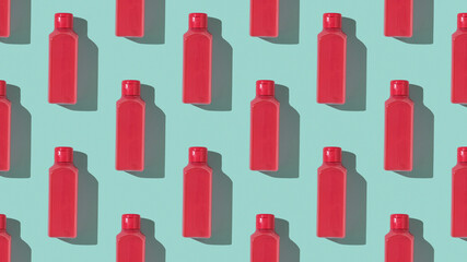 Pattern of red plastic bottles on a blue background.