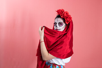 A young woman disguised as a catrina