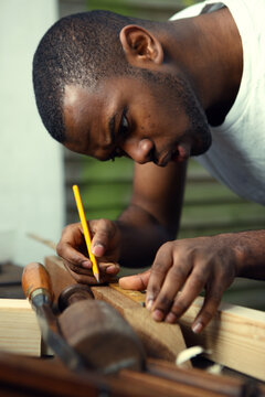 Carpenter measuring wood.