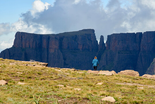 Young hiking woman admiring a speared mountain top.