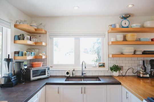 Bright modern kitchen with concrete cement counters and open shelving