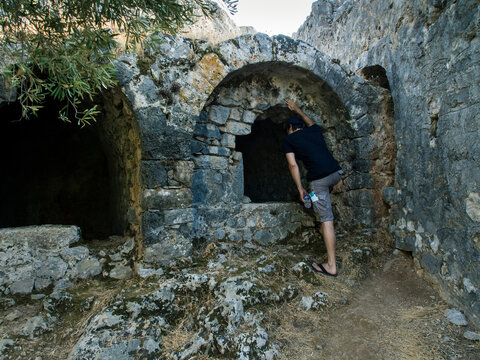 Man examining a ruined church on Gemiler Island, Fethiye, Turkey