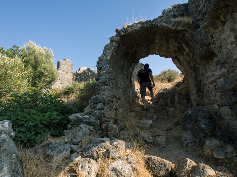 Man walking among ruins on Gemiler Island, Fethiye, Turkey