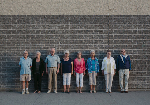 Funny portrait of grumpy caucasian seniors outside at schoolyard