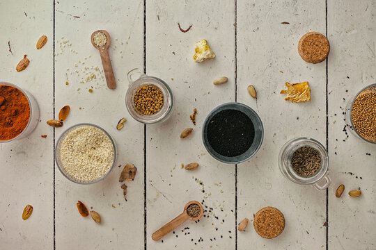 Colourful spices on a wooden table.