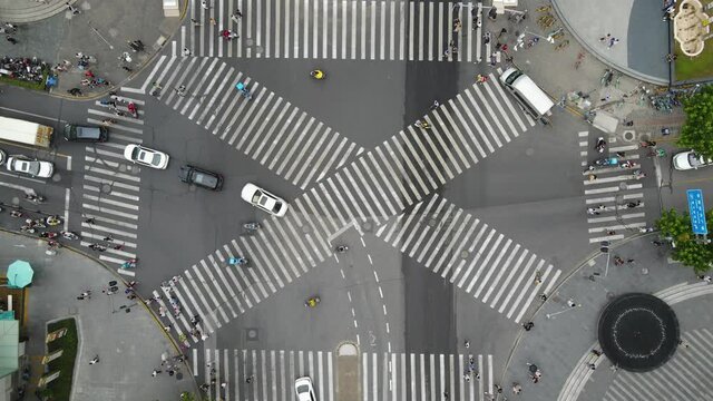 Drone aerial view of cross road with people and traffic cars in downtown. Business concept. Busy traffic in rush hour. Pedestrian walking in the street. Crowded of people urban street Shanghai China
