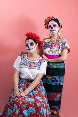 Two young women disguised as catrinas