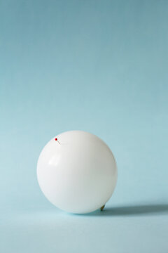 Inflated balloon with a pin inside it