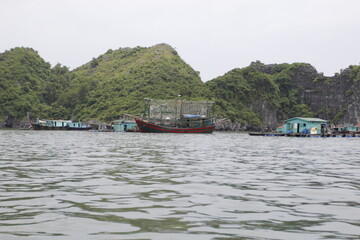Fototapeta na wymiar HA LONG BAY, VIETNAM - NOVEMBER 13, 2018: Halong Bay, Vietnam. Unesco World Heritage Site. Traditional tourist boats.