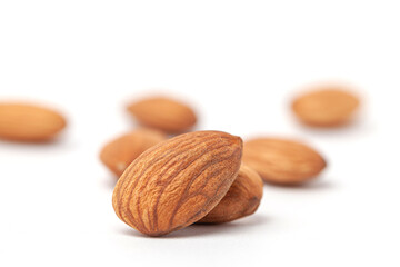 nutritious  almonds scattered on white background with blurry