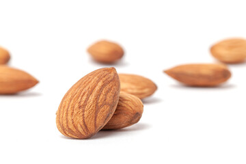 nutritious  almonds scattered on white background with blurry