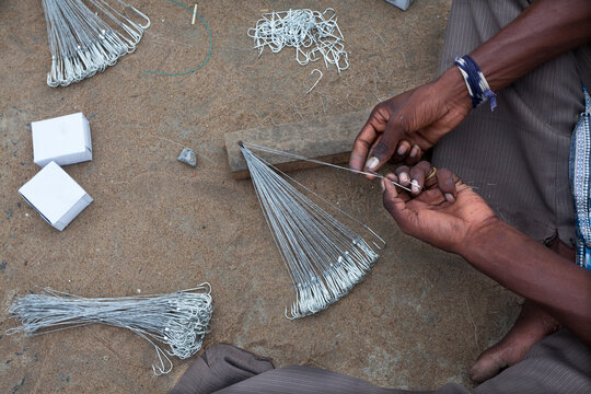 A fisherman fixing fishing hook in the fishing net