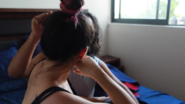 Pareja de j&oacute;venes platicando en la ma&ntilde;ana en cama dentro de casa