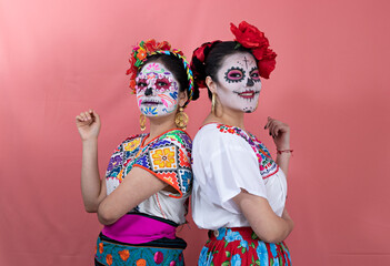 Two young women disguised as catrinas