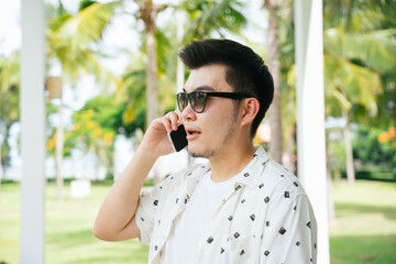 Business man talking on the phone in vacation days.