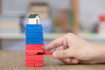 The house model that is gradually in crisis with the building blocks removed