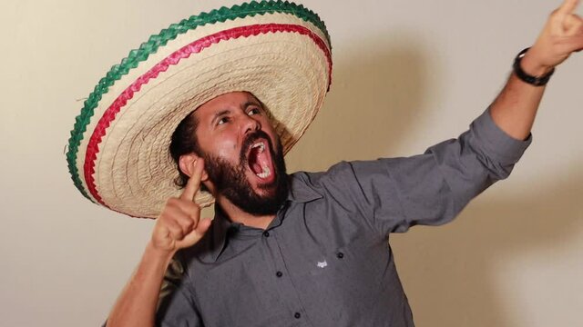 Joven Mexicano gritando con alegr&iacute;a por independencia de M&eacute;xico con sombrero