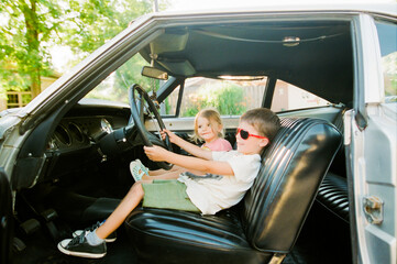 boy drives classic car