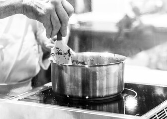 Chef cooking in a kitchen, chef at work, Black & White.