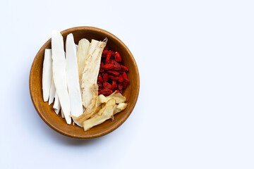 Mixed chinese herb in wooden bowl on white background.