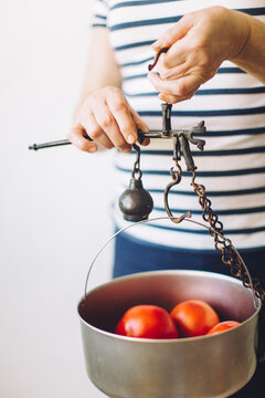 Woman holding a antique rusty scale