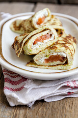 Close-up Supper Pancakes with zucchini, salmon and cream cheese.