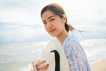 Portrait of beautiful asian woman traveler on the beach.