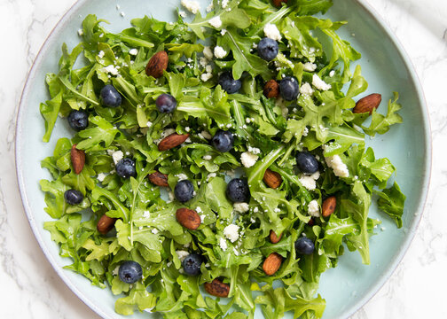 Blueberry Arugula Sala on blue plate