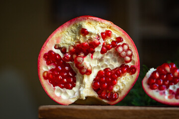 pomegranate red fruit sweet on the table and a twig of green christmas tree new year tasty treat serving size top view copy space for text food background rustic food background rustic