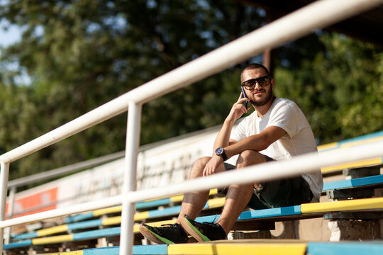 Young man standing on an empty stadium