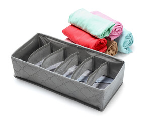Organizer with clean clothes on white background
