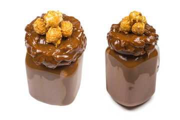 Chocolate milkshake with whipped cream, cookies, waffles, served in glass mason jar. 