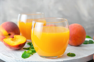 Glasses of fresh peach juice on table