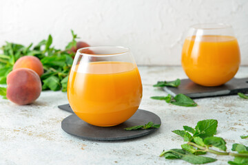 Glasses of fresh peach juice on table