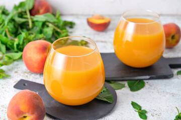 Glasses of fresh peach juice on table