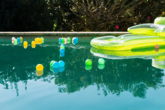 lilo and pool balls floating on the pool