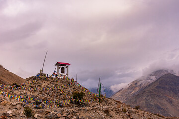 Giant Buddhist prayer wheel in Nako village in background at Spiti valley in Kinnaur district of Himachal Pradesh, India.