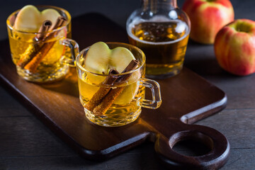 Hot apple cider cocktail with cinnamon and apple slices