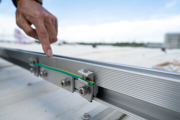 installing grounding in steel bar of solar rooftop power system by barehanded stock photo