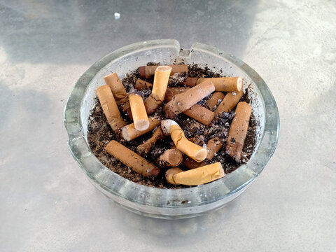 Cigarette butts and cigarette dust in the ashtray