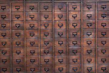 Old wooden textured drawers chest. Background of rustic wooden furniture.