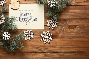 Beautiful composition with Christmas greeting card on wooden background